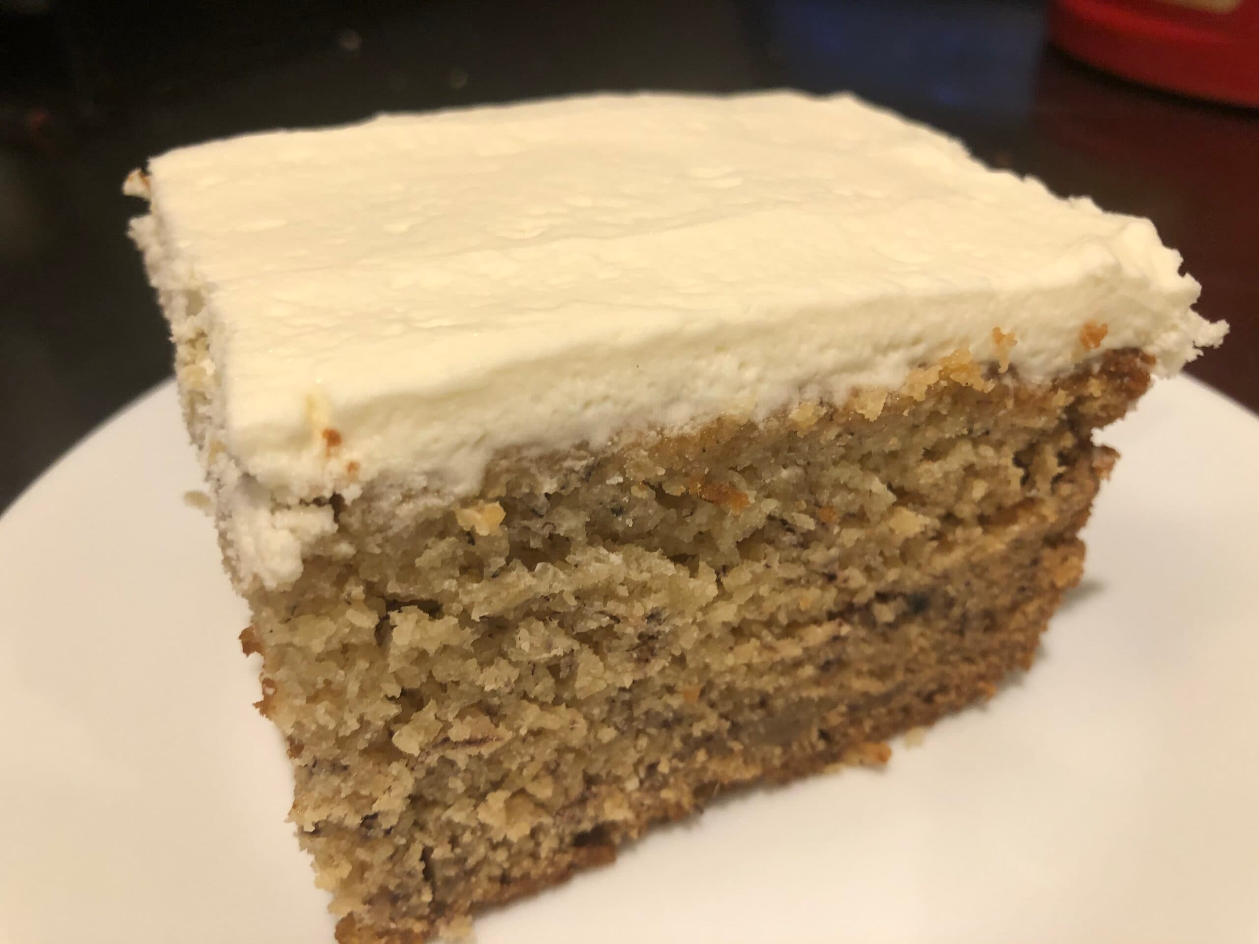 A slice of cake with a thick layer of frosting on top.